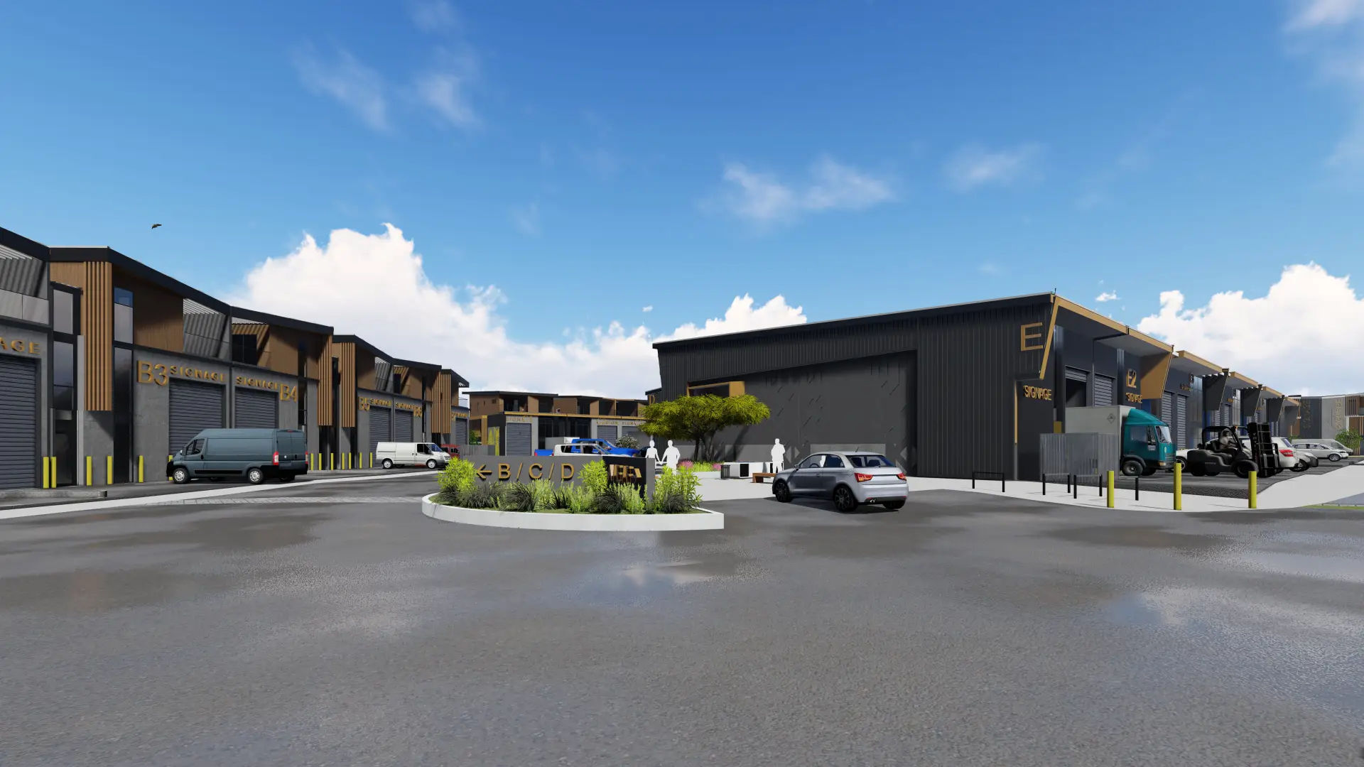 The precinct street, with warehouse blocks B, C and E lining the road, gold signage on the facades and a landscaped median